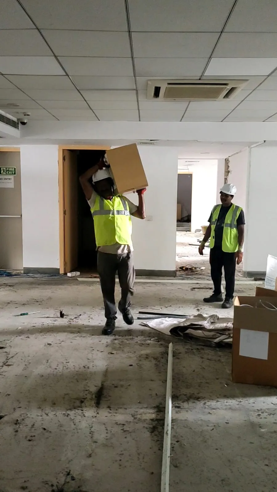 Deconstruction technicians dismantling complex modular workspace components cleanly inside an IT corridor block in OMR Chennai.
